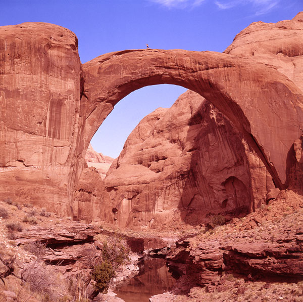 Rainbow Bridge with man on top, by Stan Jones